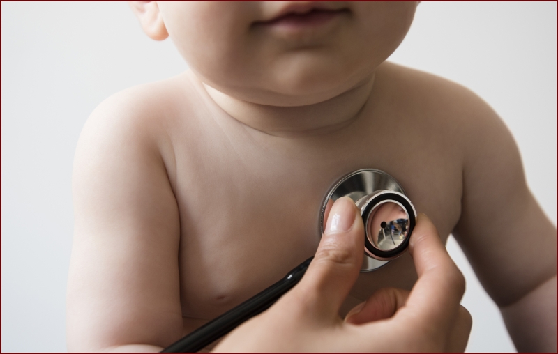 Infant being examined  by physician